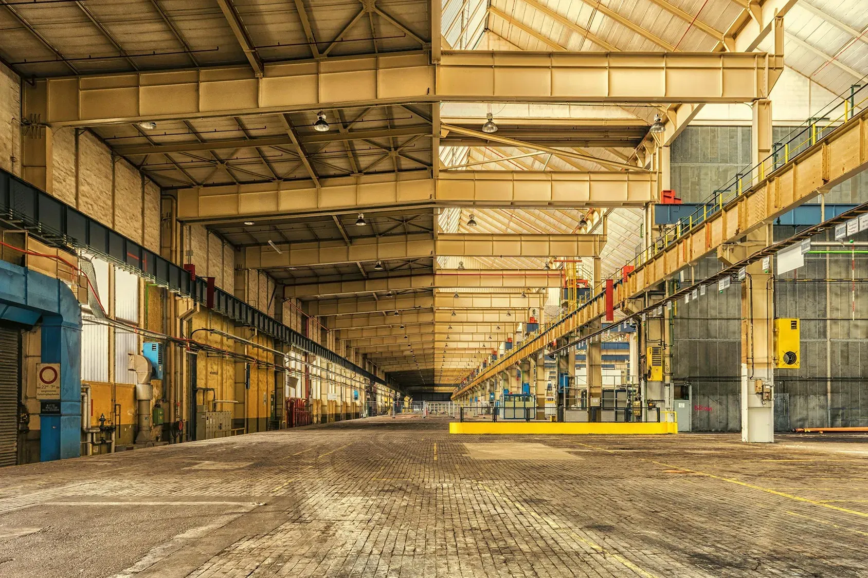an empty warehouse with a yellow fire hydrant